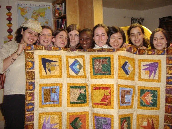 Xochilt's Pearson College UWC Housemates holding up a quilt they made