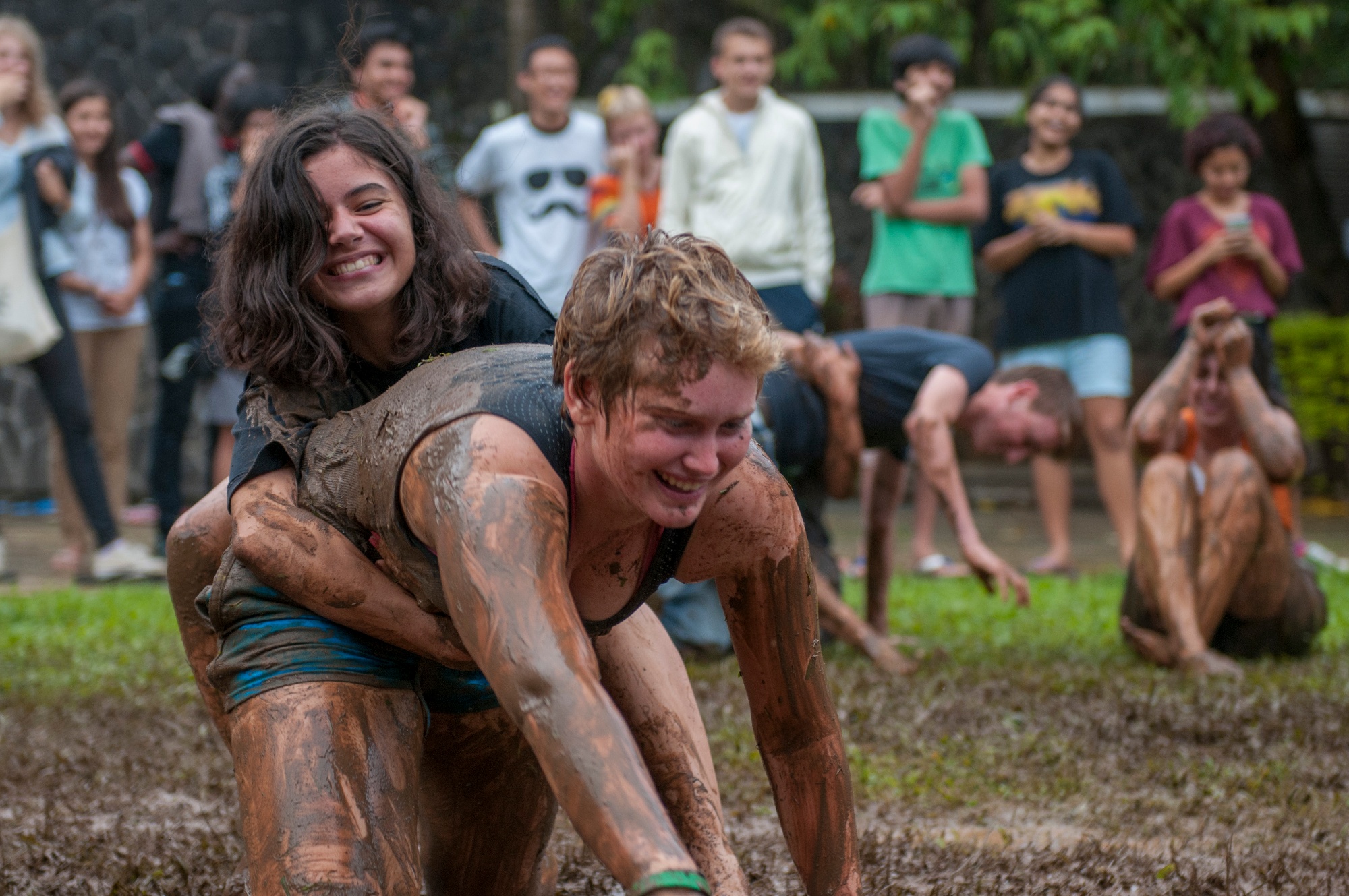 Students enjoying sport outside, laughing and getting messy