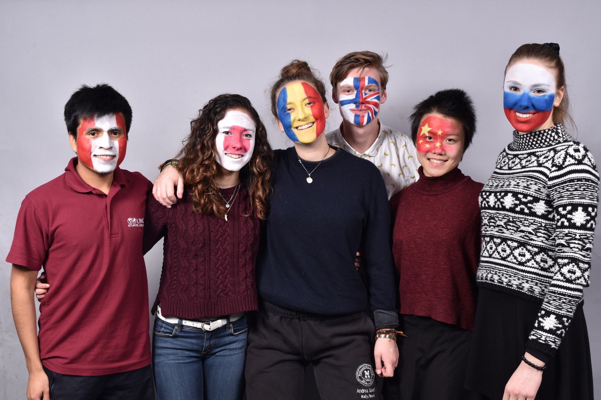 UWC students with their nation's flags painted on their faces.