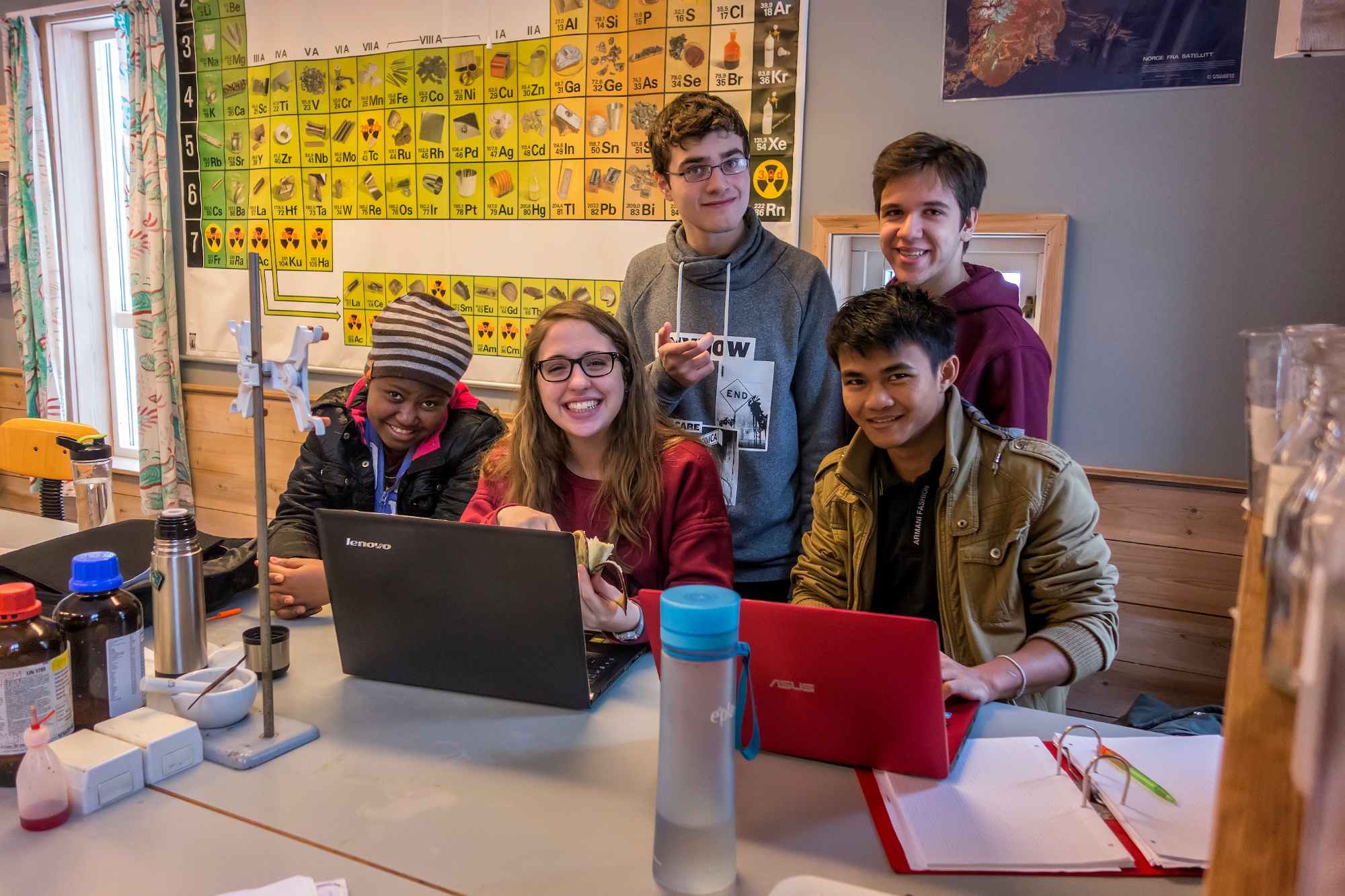 A group of UWC students collaborate on a classroom project