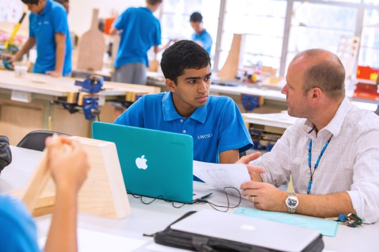 UWC South East Asia student sits in deep discussion with a tutor